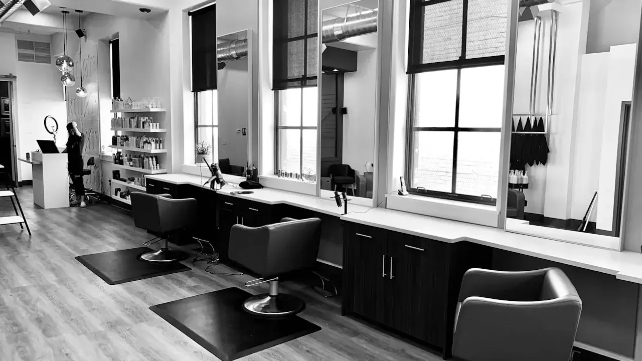 Modern salon suite interior with private styling stations and upscale finishes