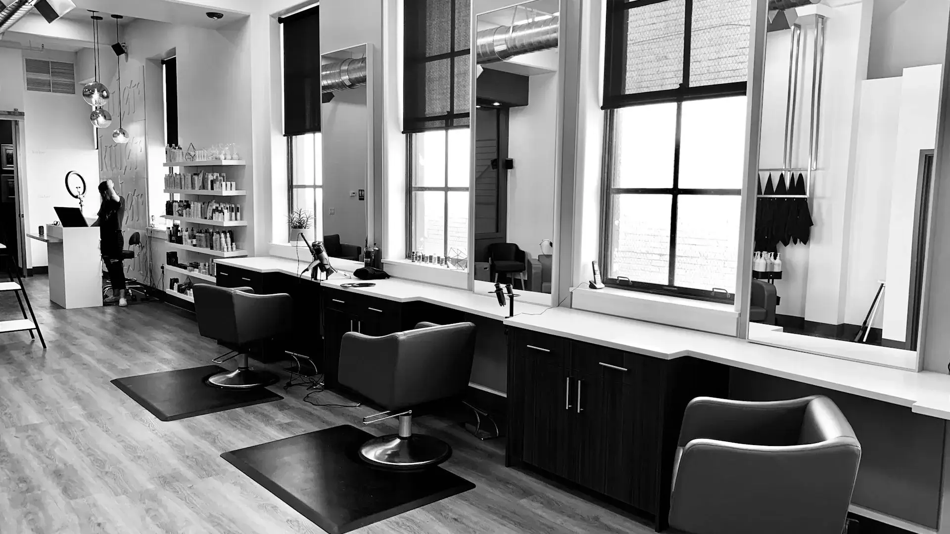 Modern luxury salon suite franchise interior with individual suites and warm lighting